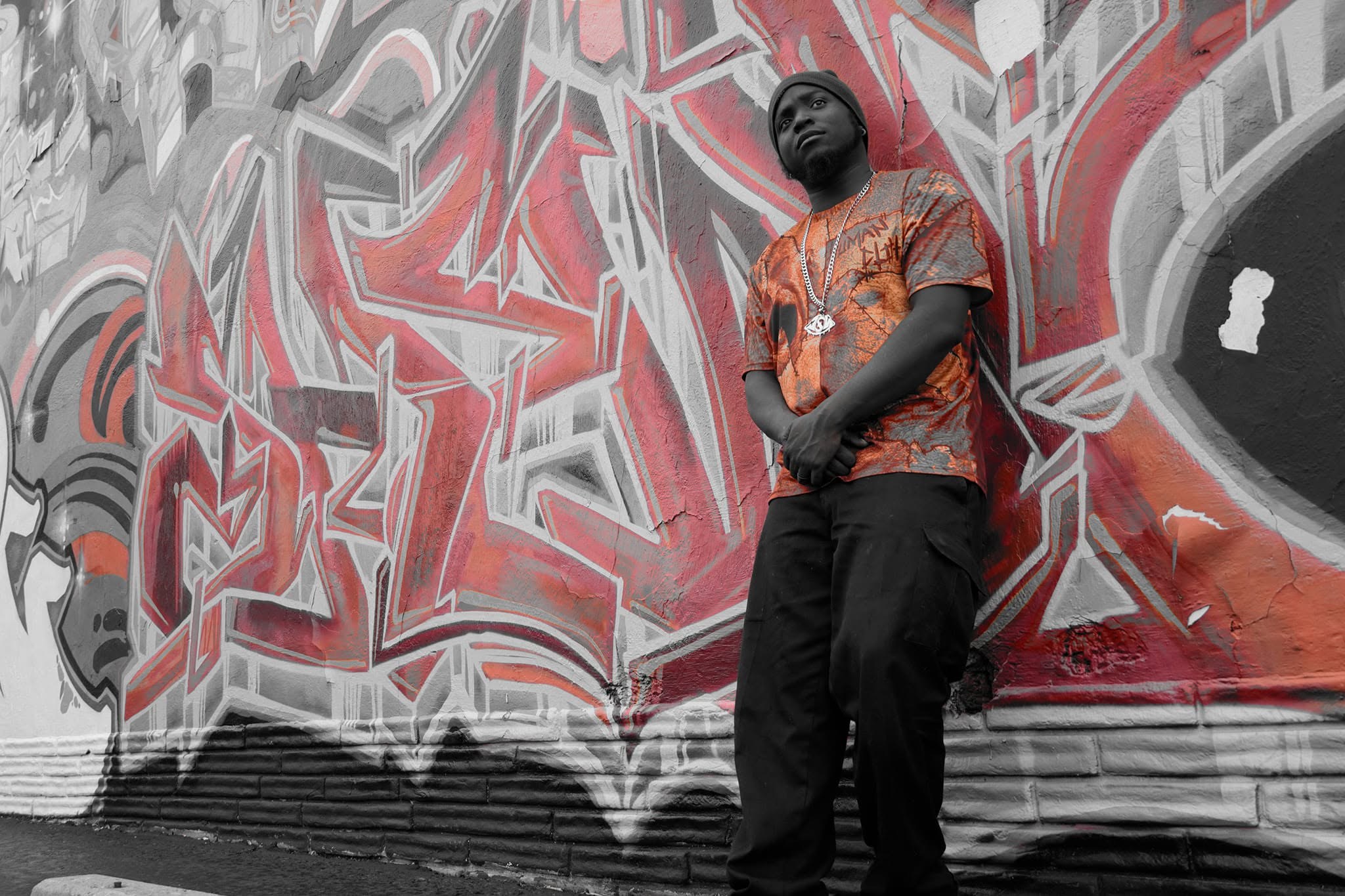 Artist portrait in front of a graffiti wall by J Sturgis Media