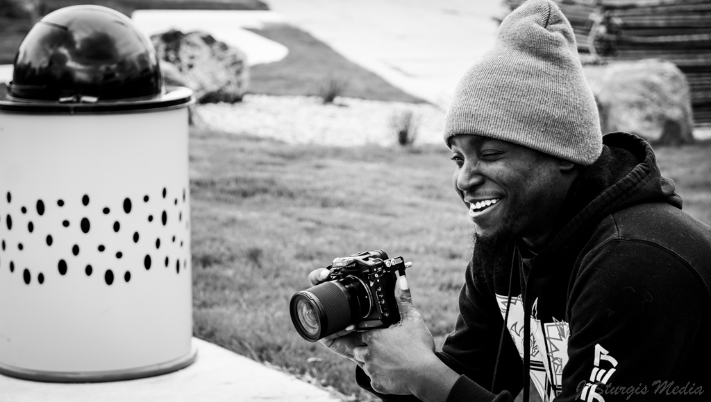 Jaz Sturgis holding his camera during an outdoor portrait session